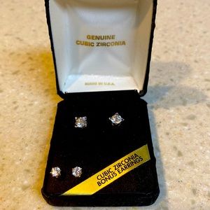 Pierced ear studs with zirconia stones. One is silver color & one gold color.